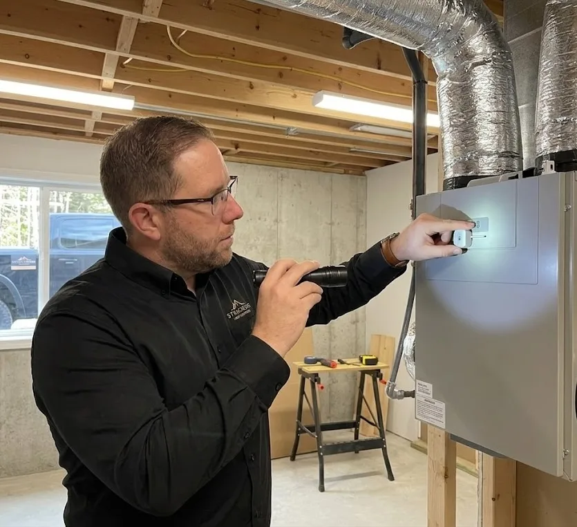 Modern utility room with HRV system and electrical setup under inspection