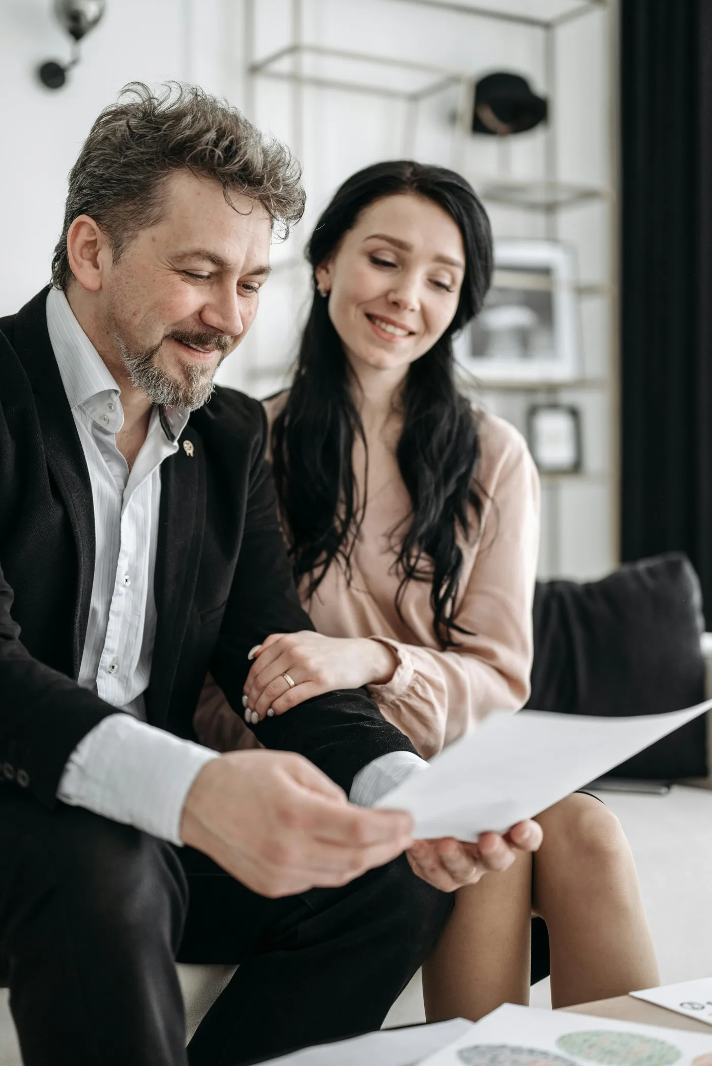 Couple reviewing inspection report and paperwork before condition removal